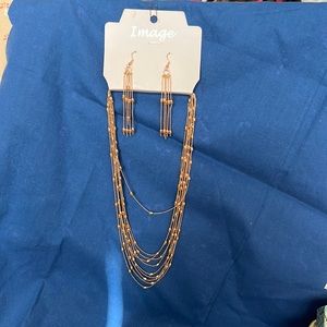 Image gold tone earrings and necklace set. Ear wires with holders on back.